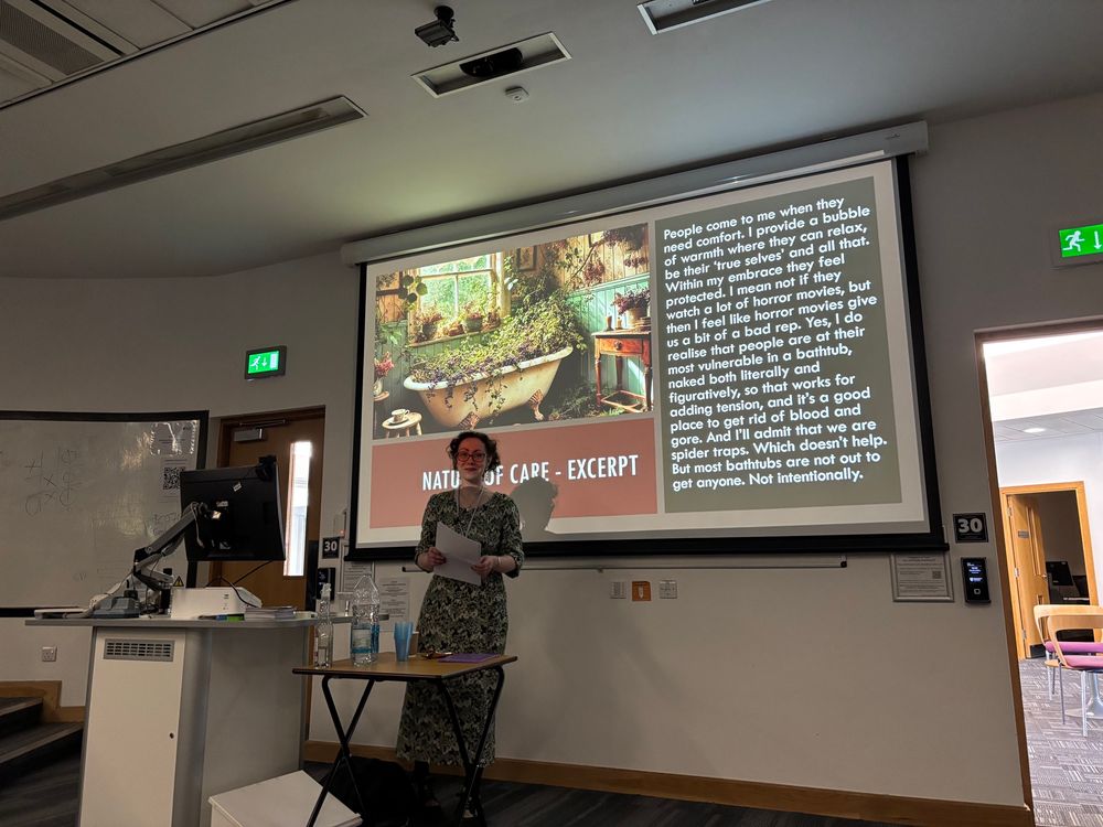 Woman giving lecture in front of screen