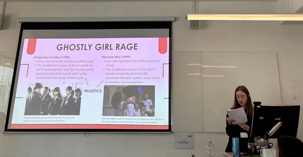 Woman giving a conference paper 