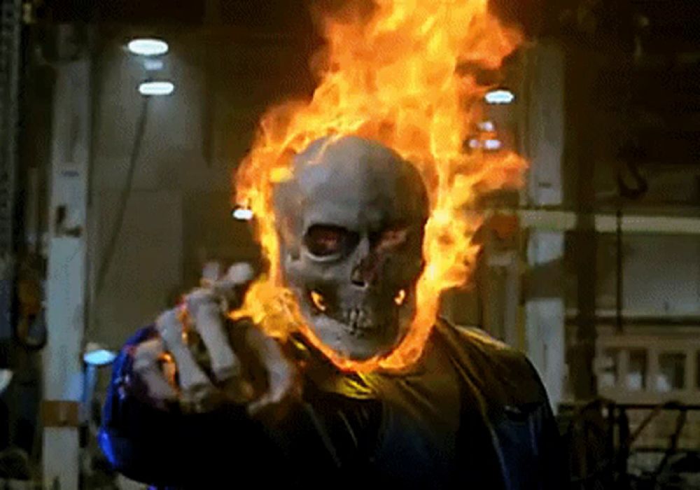 a ghost rider with flames coming out of his head is pointing