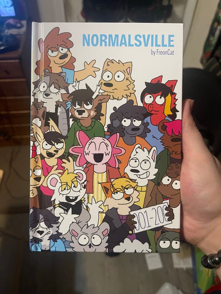 A physical copy of the first 200 issues of the webcomic “Normalsville” by FreonCat.