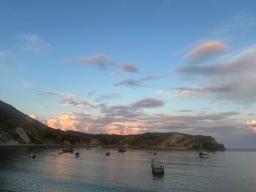 Lulworth Cove in Dorset at sunset. 