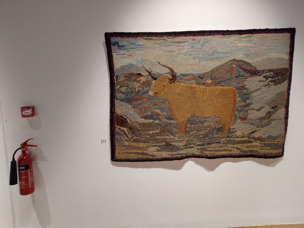 Another rug featuring a cow in the fells, this one with long horns