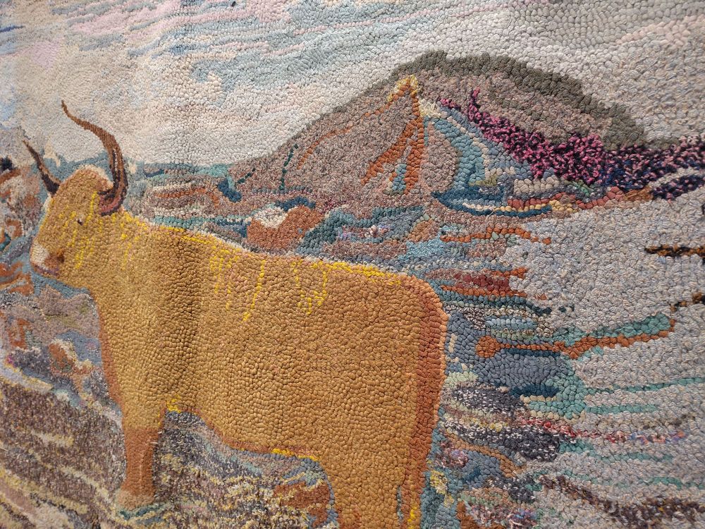 Closer detail of the longhorned cow rug. Pieces of old rag make up each point of the image