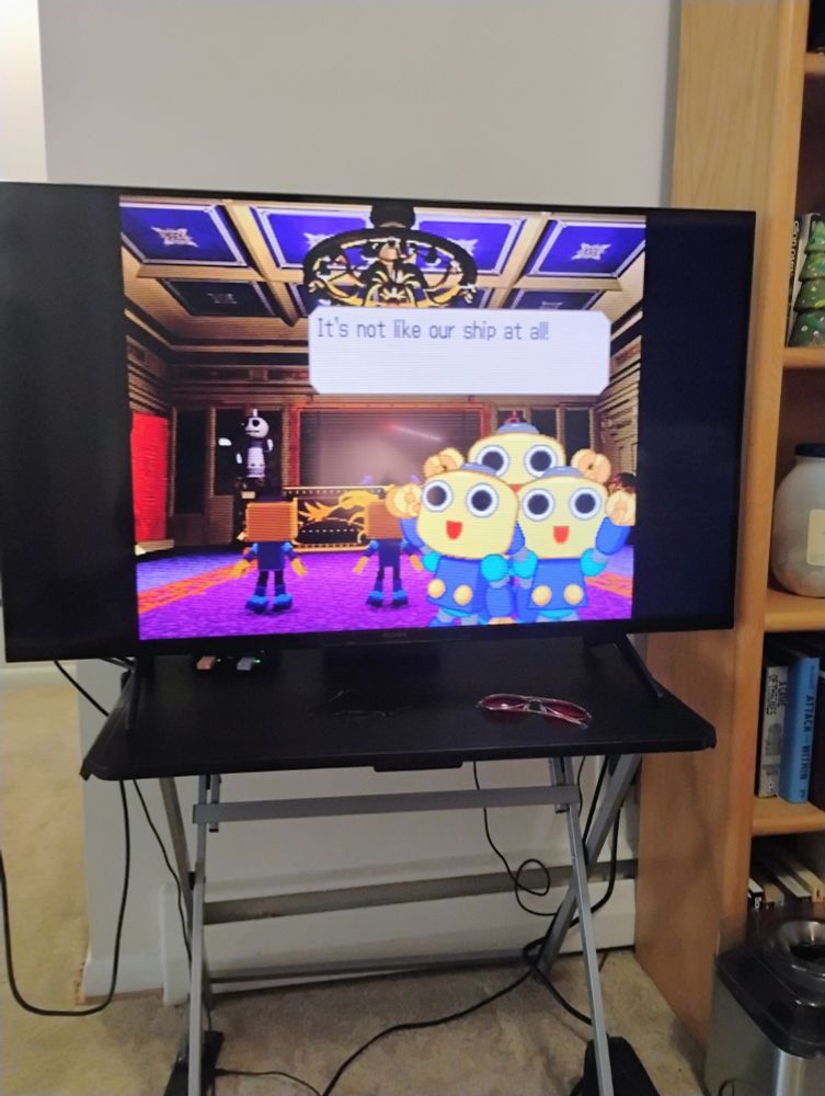 Three servbots in a fancy meeting room saying "It's not like our ship at all!"