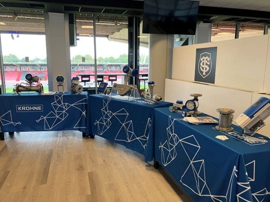 a table with blue tablecloths and a screen