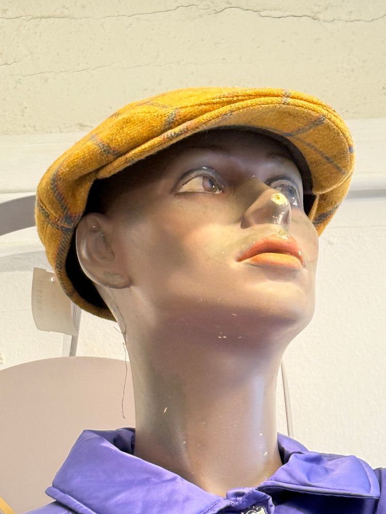 Der Kopf einer Schaufensterpuppe mit einer gelben Kappe 