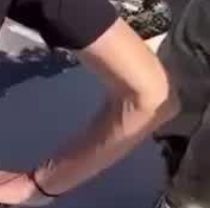 Kristi Noem's right arm and elbow from behind, looking like a veiny chode for some reason.