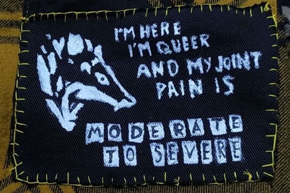 Artistic drawing of a possum head with the quote "I'm here I'm queer and my joint pain is moderate to severe".