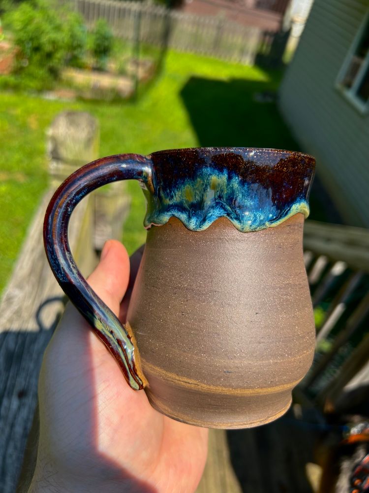 New clay body darkened with a black stain and more raw clay exposed in the final firing