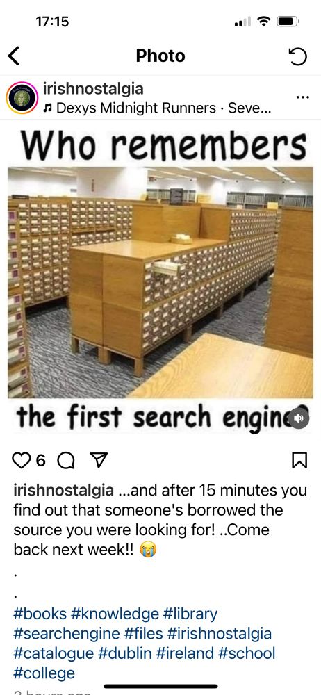 A humorous Instagram post from the account “irishnostalgia” featuring a photo of an old-fashioned library card catalog—rows of wooden cabinets with hundreds of small drawers. Above the photo, bold text reads: “Who remembers the first search engine.” The caption adds, “…and after 15 minutes you find out that someone’s borrowed the source you were looking for! ..Come back next week!! 😭” The post is accompanied by hashtags related to books, libraries, and nostalgia.