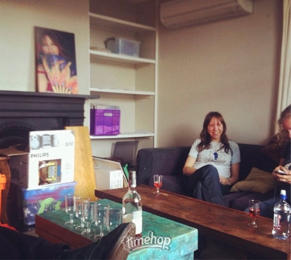 Photo of Joanna’s very empty house featuring her sister Karen sitting on the couch 