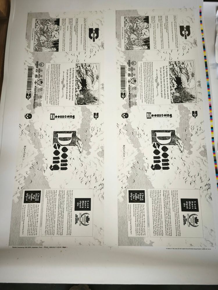 Doomsong dust jackets, waiting to be folded