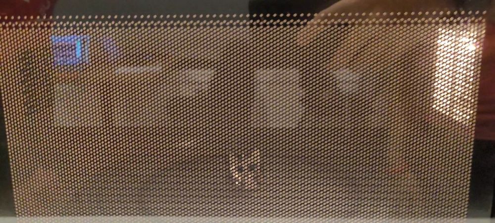 A small 3d-printed boykisser in a microwave
