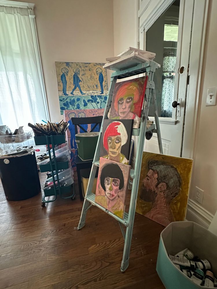Three portraits climb a ladder in an artists studio each portrait was started in the same way and then allowed to develop and change creating very distinct finished images.  