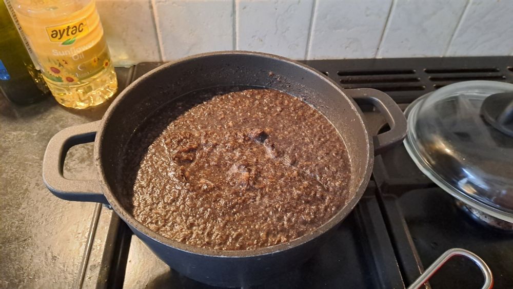 Brown soup in a black bowl