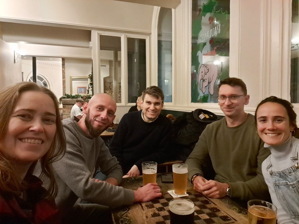 5 people at a table, smiling at the camera.
