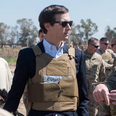Jared Kushner in a little vest that says KUSH