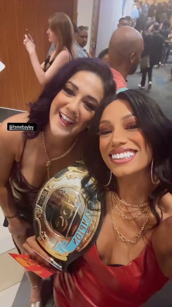 A picture of wrestlers Bayley and Mercedes Mone posing at a special event. 