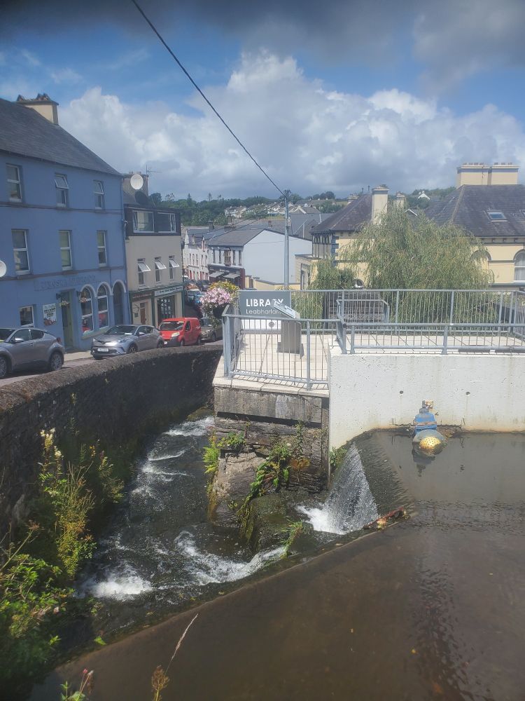 A waterfall built around a balcony next to a street