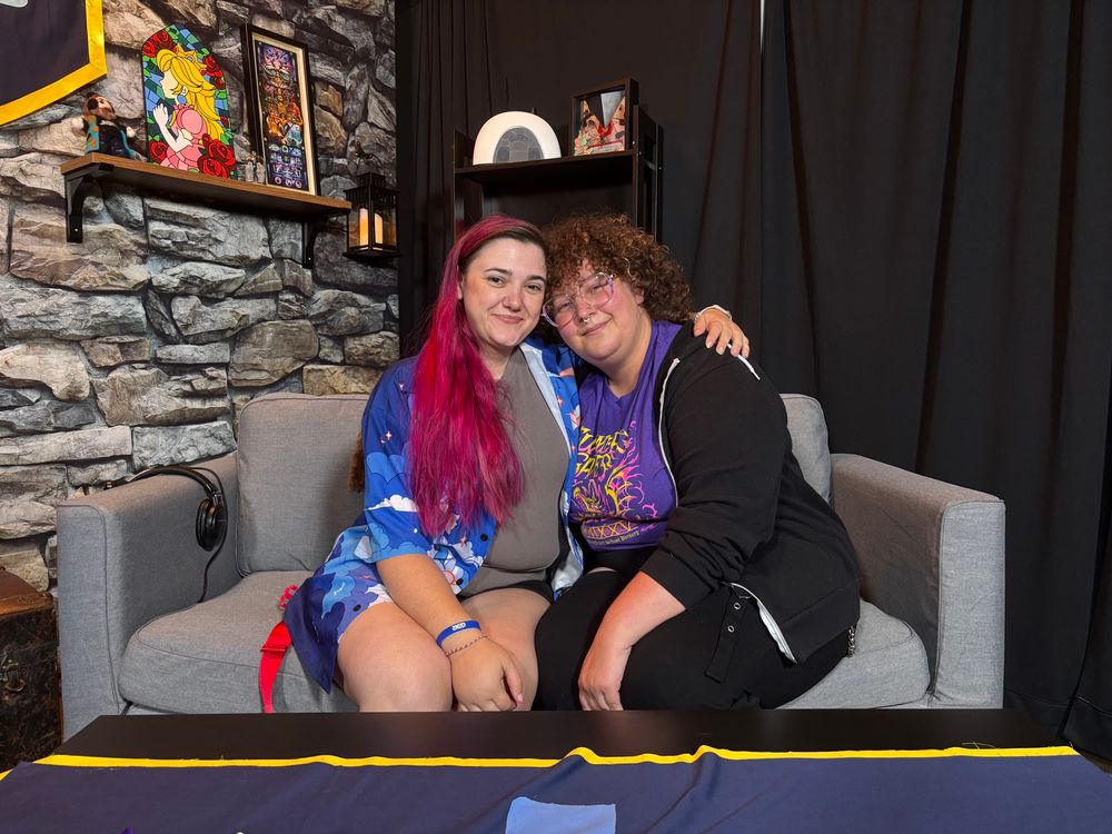 Crime and Lazlo sitting and hugging on the prize set at Summer Games Done Quick 2025.

Photo Credit: Greggles