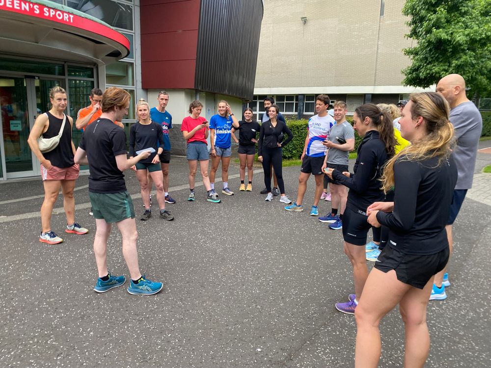 A group of runners outside a sports centre ready to start a run