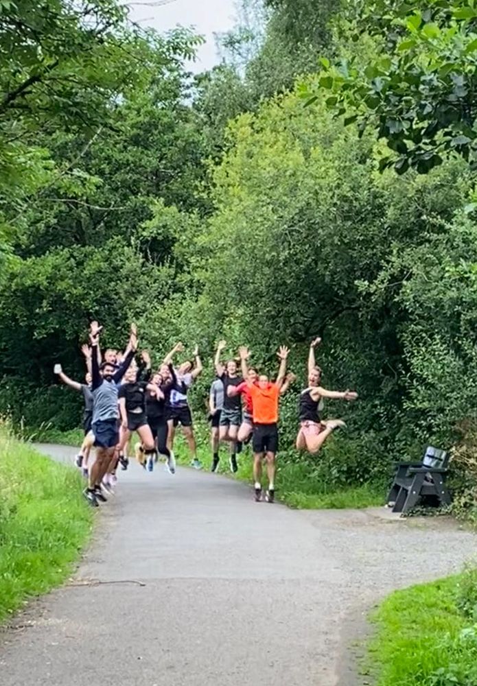 Runners at the halfway point in a mid-air jump