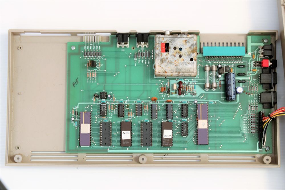 This picture is of the TED Developer Alpha motherboard, number P15, within the C64 case.  The C64 opening were used for various ports and the power switch and this unit still used the normal C64 compatible joysticks.  The main TED chips are hand bonded and you can see cellophane tape holding the lids on.  