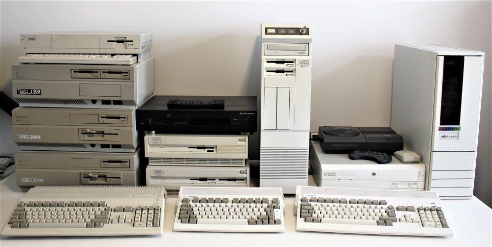 This picture shows a number of Amiga computers including from left to right (front) A500, A600, A1200 (rear) A1000, A1500, A2000, A2500, CDTV, A3000, A3000UX, A3000T, CD32, A4000, A4000T.