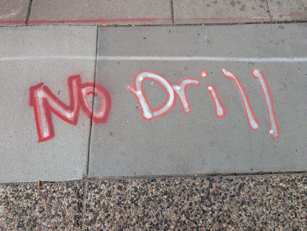 sidewalk in minneapolis has "no drill" spraypainted across it