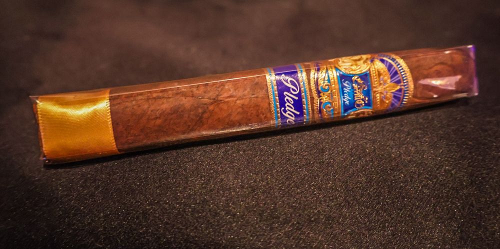 EP Carrillo Pledge cigar on black surface.
