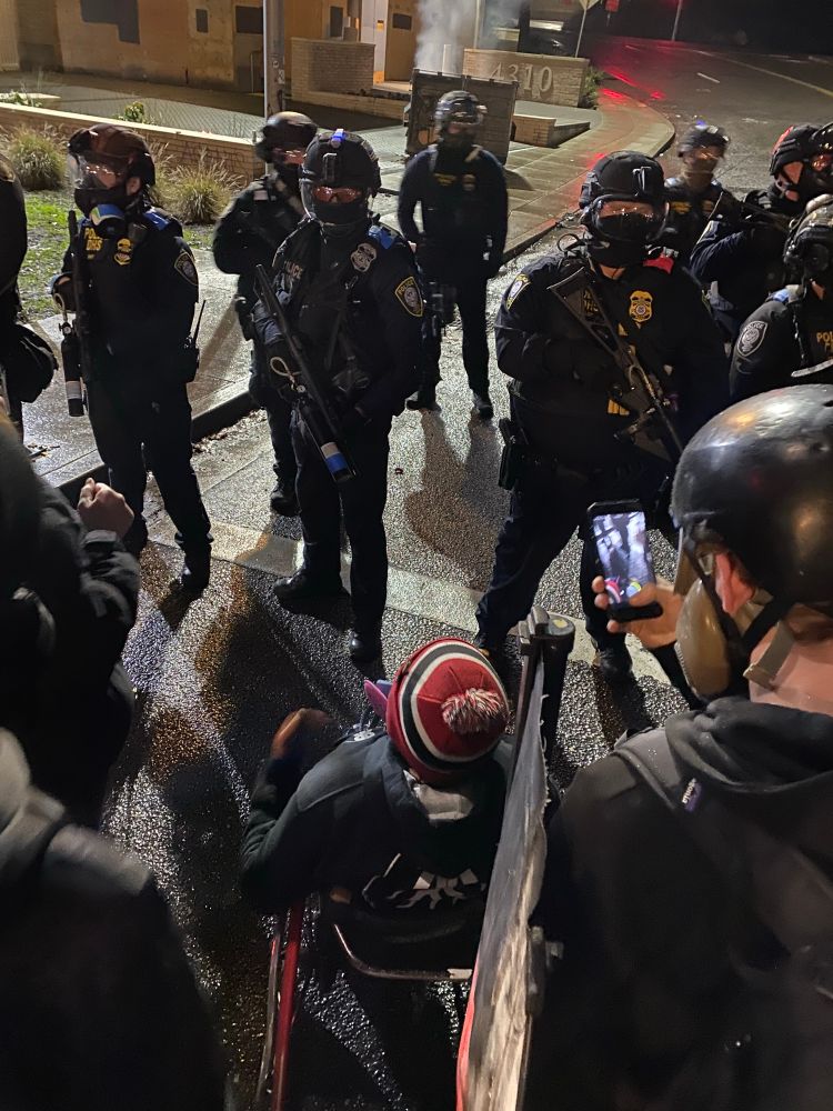 aggressive cops in riot gear 
