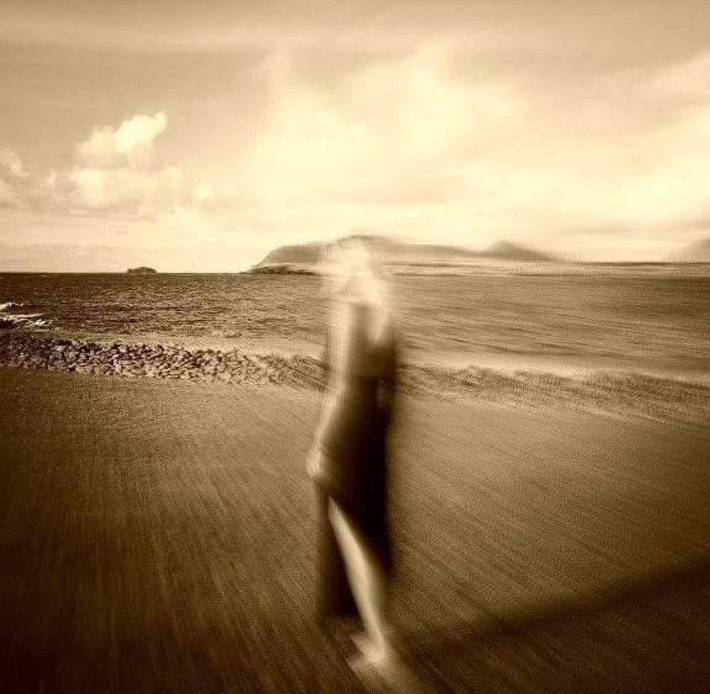 A blurred picture of a blonde woman (me) near the edge of the Atlantic.