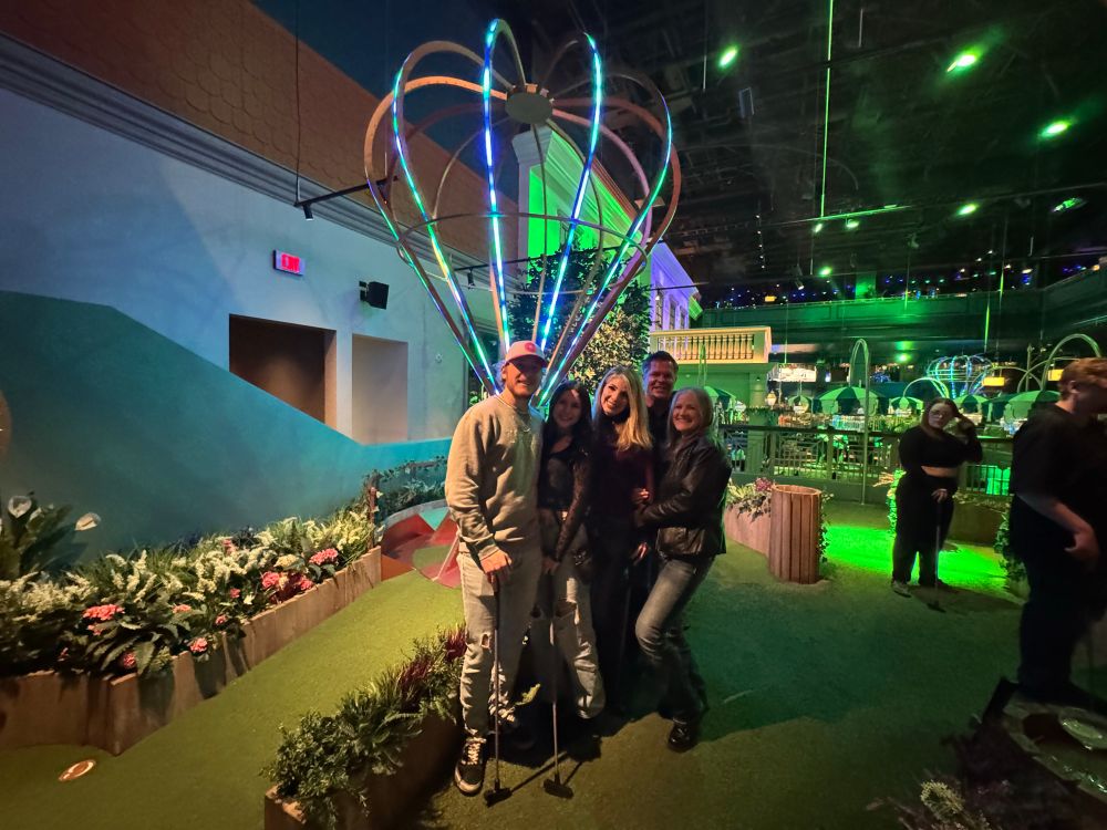 My family standing in front of the balloon lit in neon