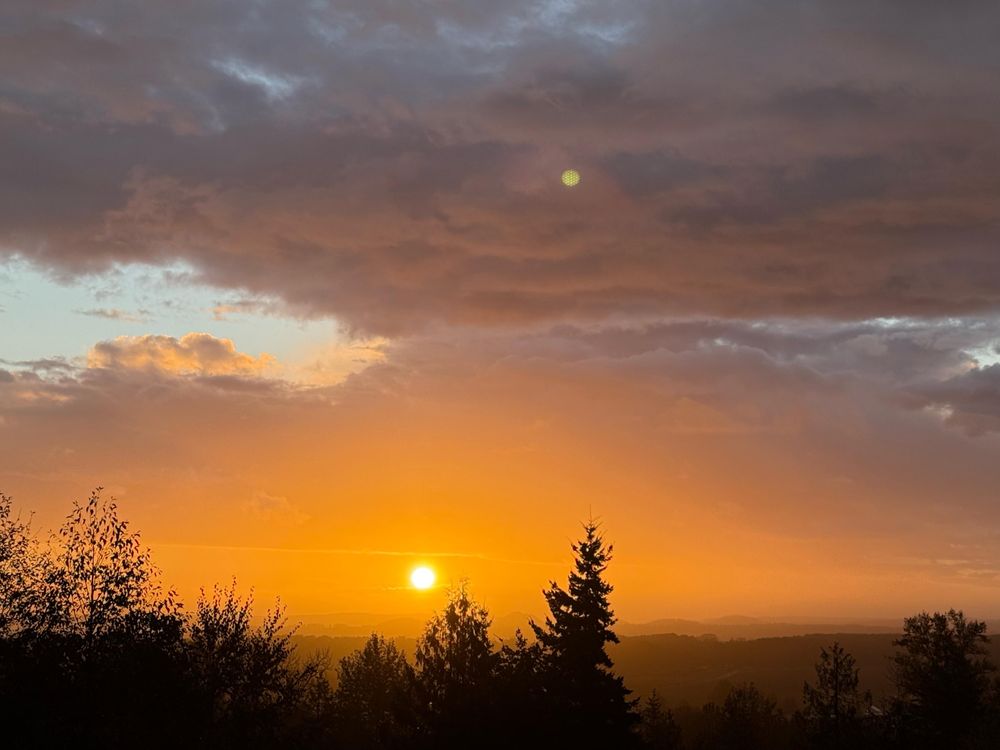 A sunset thru clouds and rain