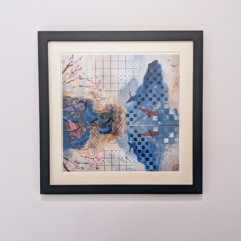 A framed print called "What The Mirror Holds." It's an abstract painting with lines, squares and textures that are mirrored horizontally with flying paper cranes painted.