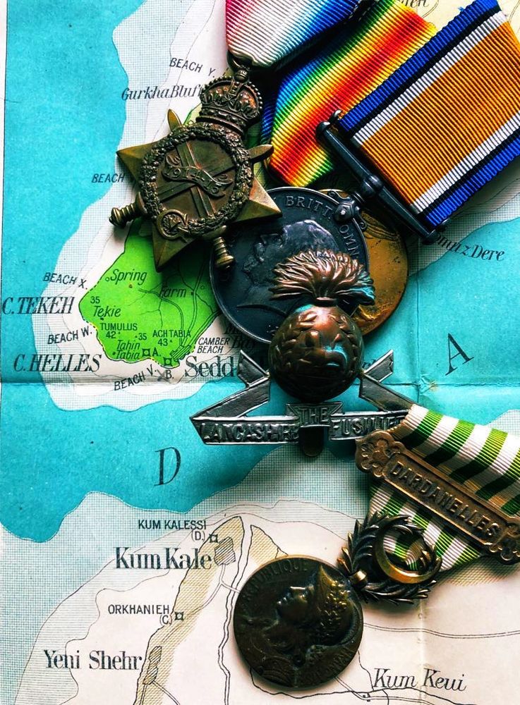 Map of the Gallipoli peninsula in 1915, with medals of a Lancashire Fusilier at W Beach and of a French soldier who landed at Kum Kale