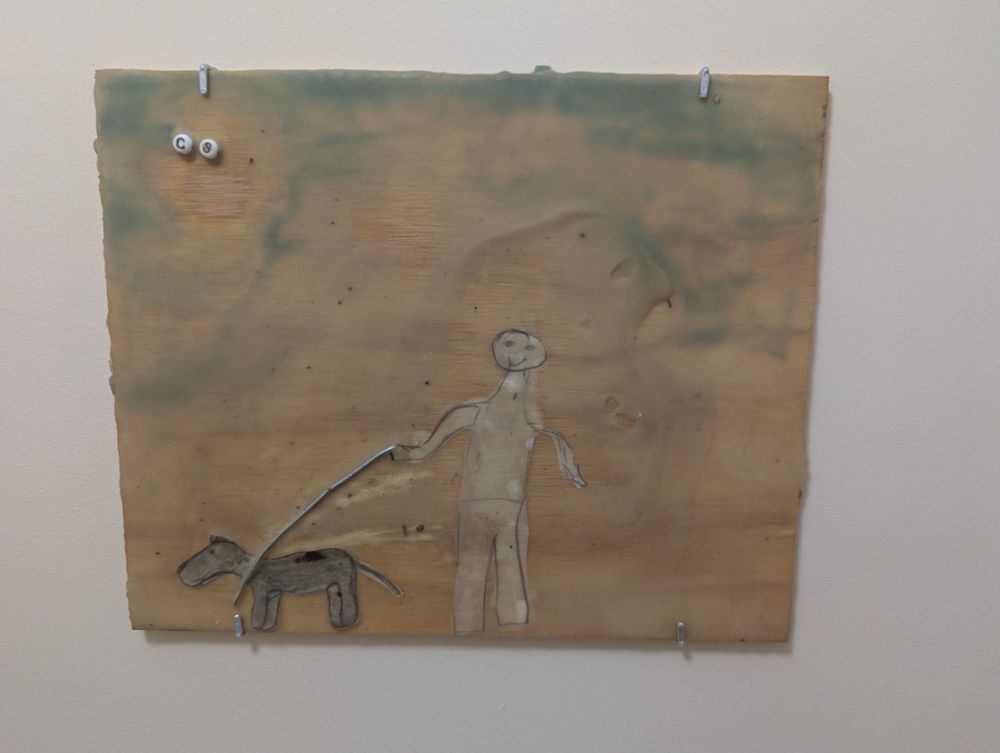 A terrifying image of a huge man walking a dog on a metal lead. 