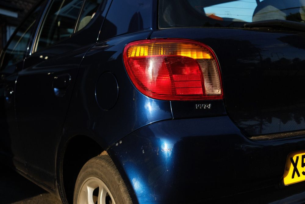 Photo of rear of my 2000 Yaris car. Showing my newly amber tinted indicators.
