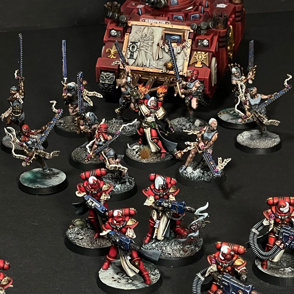 A squad of three dominator sisters with meltaguns. Right behind them, ten repentias plus mistress and their rhino APC.