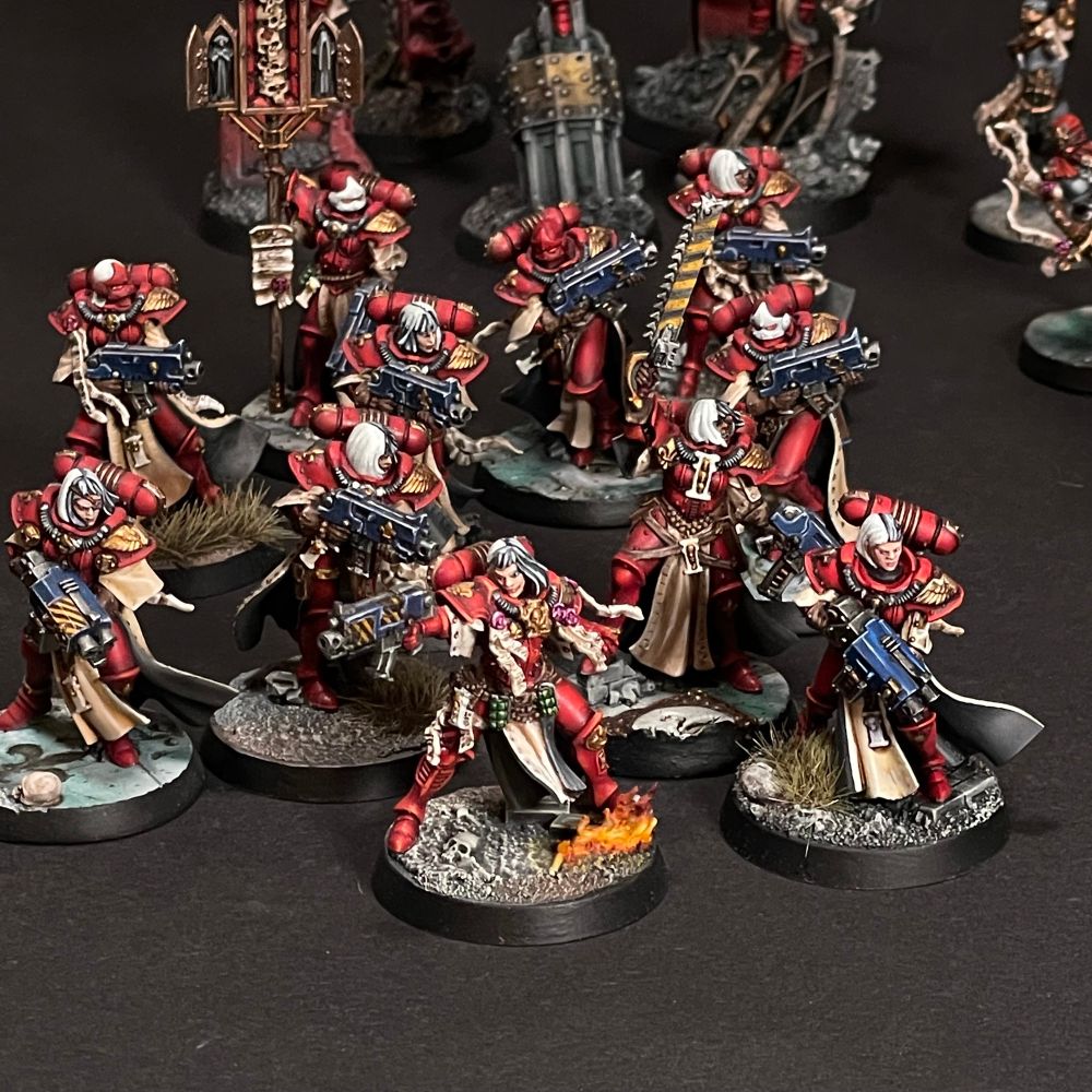 Closeup of a sister superior with boltgun as army leader, next to a troop with two Stormbolters.