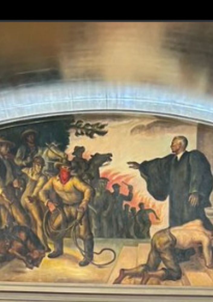 Close up of the mural of a judge protecting a man from a lynch mob
