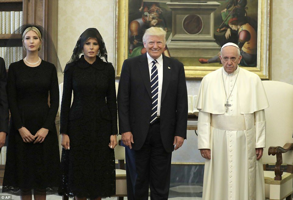 Melania, wearing head to toe black with a black veil on her head, looks like she's a grieving widow. Too bad trump is alive and well standing right next to her. The Pope, also in the pic, looks like he's wishing death on trump too.