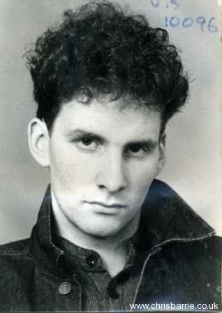 A black and white photo of a young Chris Barrie.