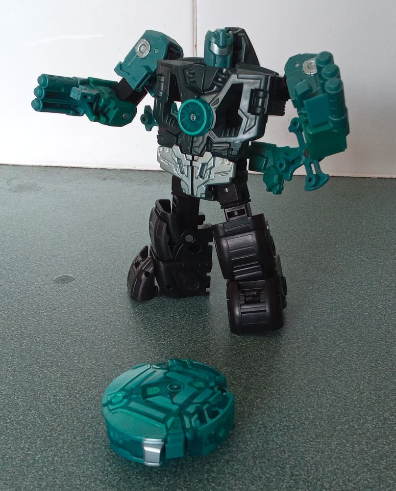 A mainly black robot squares off against a translucent disc.