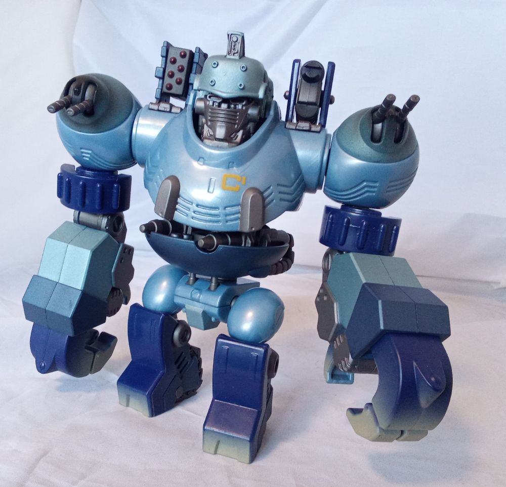 A blue, steampunky sort of robot with proportions like a gorilla, and shoulder turrets. Angled view, weapons deployed.