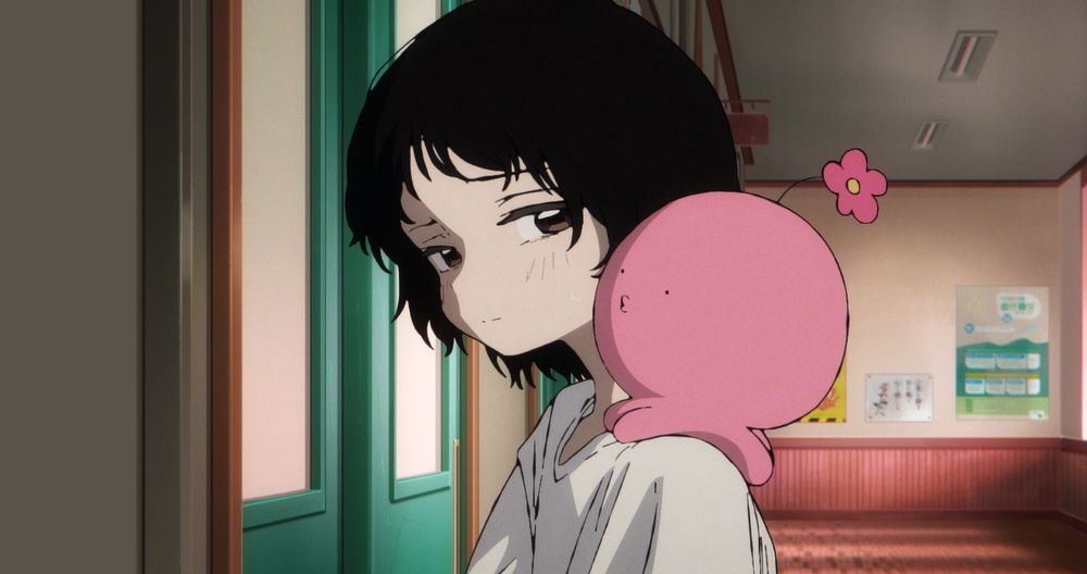 Image from the 2025 anime, Takopi's Original Sin. The main character, a young girl named Kuze, has a spherical pink octopus sitting on her shoulder as she stands in a classroom.
