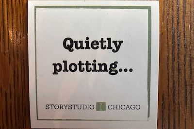The words Quietly Plotting on a sticker from storystudio chicago