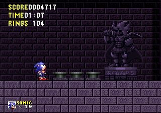 We can see Sonic The Hedgehog Looking at a Statue that is place behind 3 switches