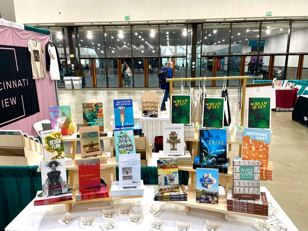 Bookfair table with assorted Acre Books titles displayed. 