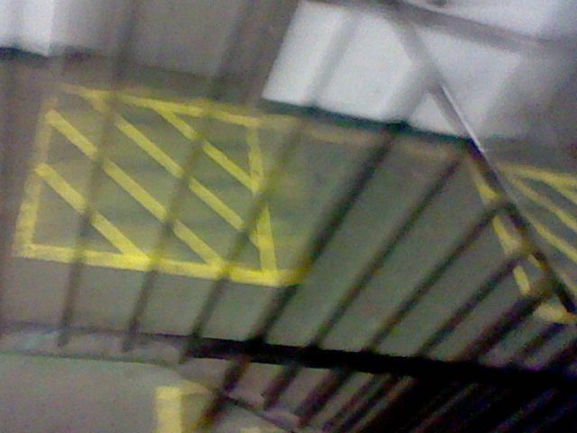 A third blurry photograph of a stairwell in Level 35 of the Backrooms.